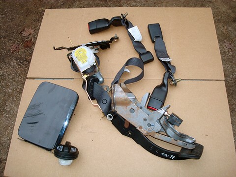 Gas_tank_cover_and_seat_belt_tensioner.jpg